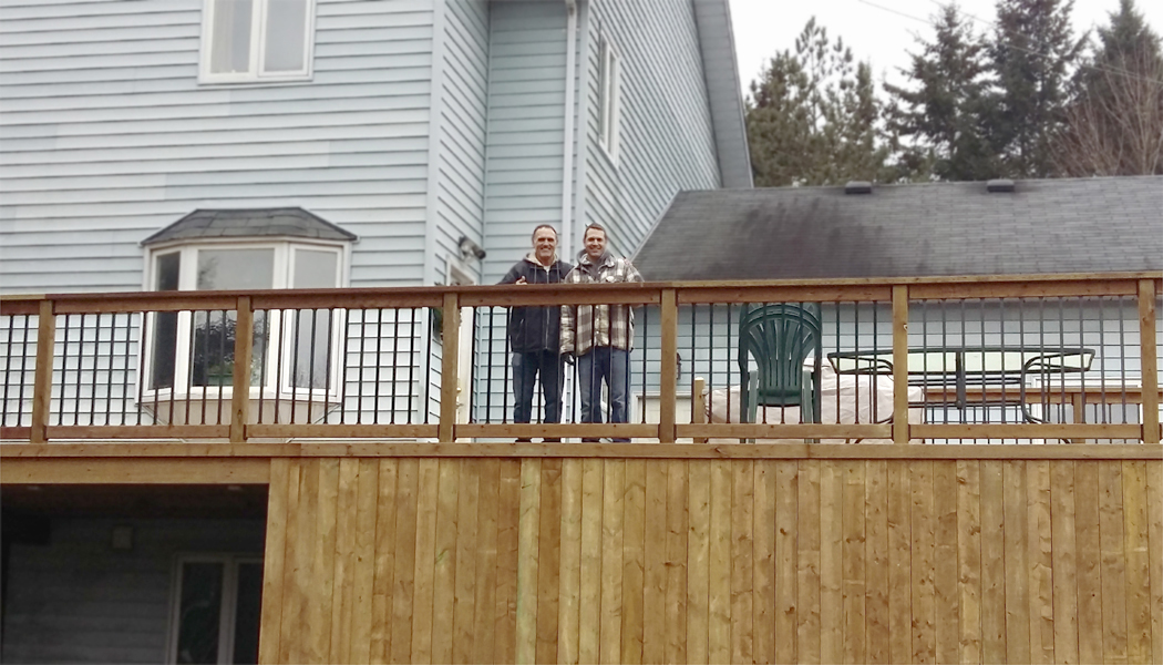 Brown Treated Lumber Deck with Black Galvium Balasters