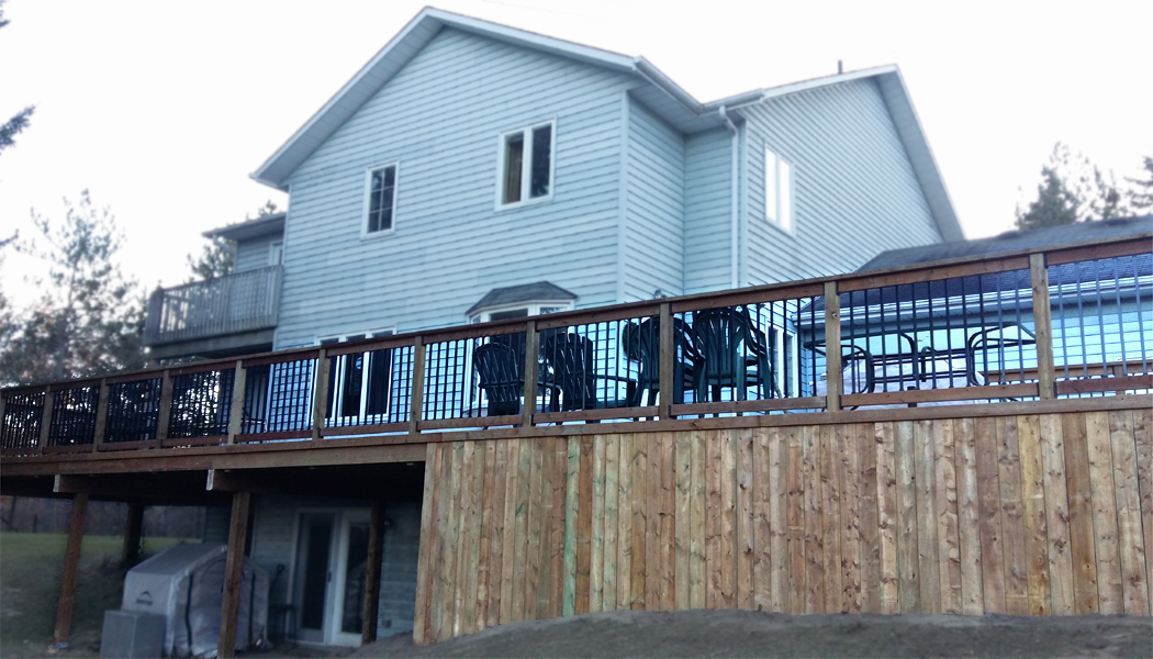 Brown Treated Lumber Deck with Black Galvium Balasters