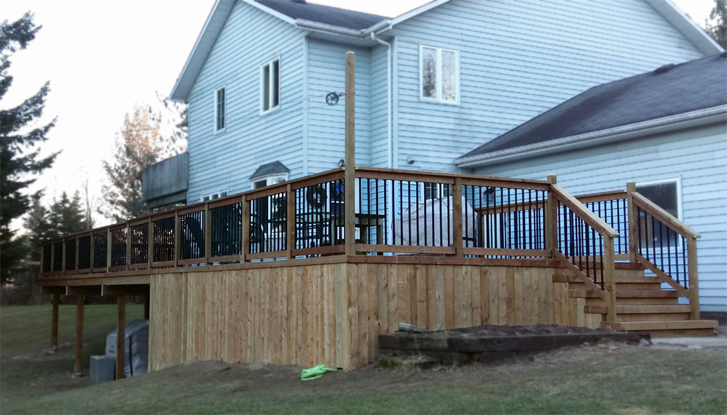 Brown Treated Lumber Deck with Black Galvium Balasters