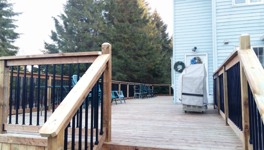 Brown Treated Lumber Deck with Black Galvium Balasters